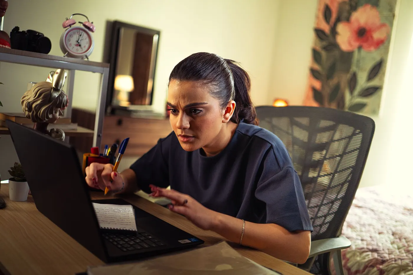 An analyst studying charts on a laptop at a desk